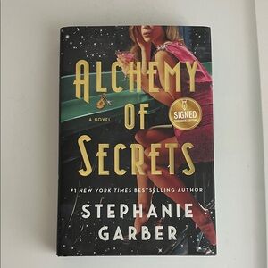 Alchemy of Secrets by Stephanie Garber — Black & Pink Hardcover (Signed)